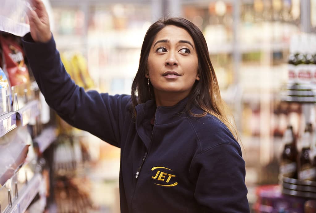 Shop employee arranging shelves